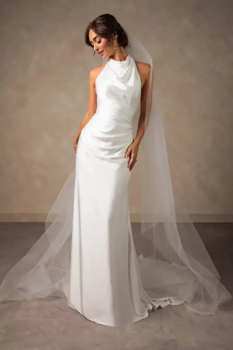 model is wearing a sleeveless fitted bridal gown